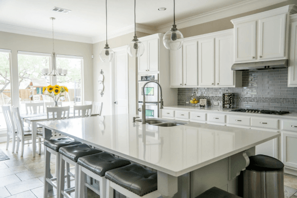 White kitchen with large island in Spectrum Quartz and Exclusive Pacshore Quartz